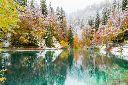 Between autumn and winter. Warm and cold reflections of snow on Lake Fusine. © Nicola Simeoni