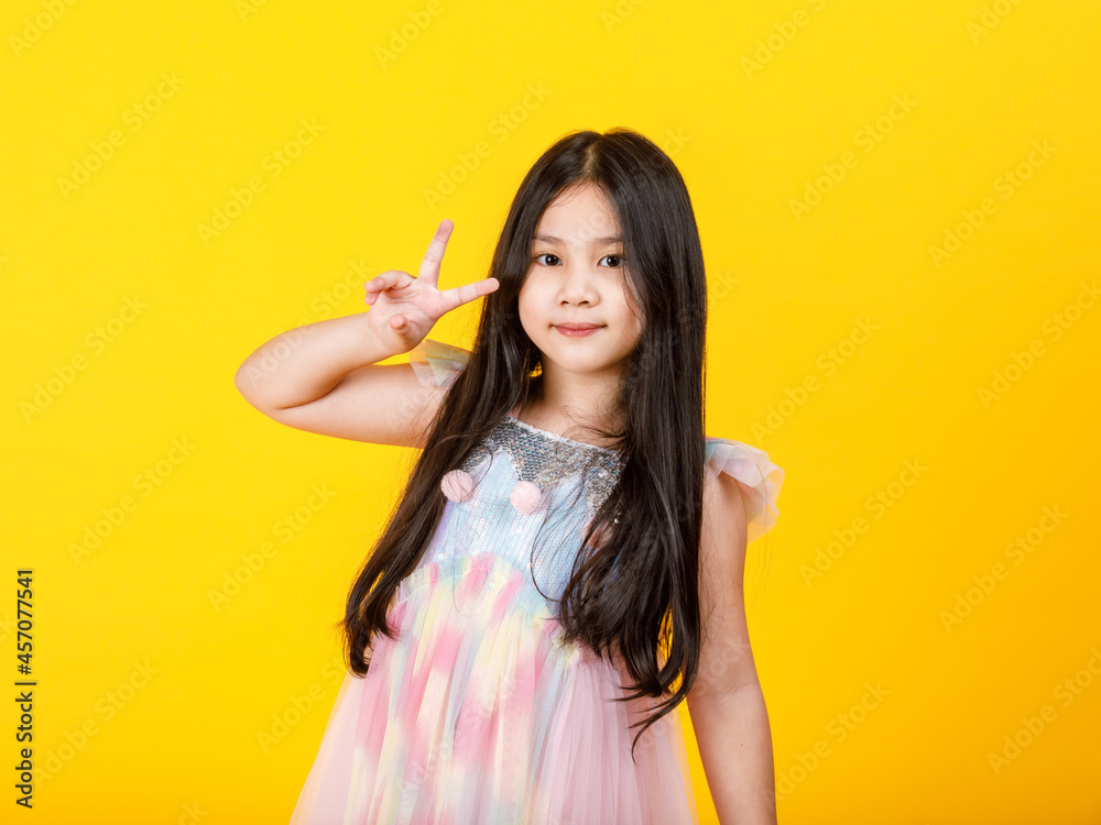 Lovely cutout portrait of young Asian girl on cute casual kid dress do attractive finger gesture as confident victory sign with cheerful face to lively express sure success, warranty satisfied Lovely cutout portrait of young Asian girl on cute casual kid dress do attractive finger gesture as confident victory sign with cheerful face to lively express sure success, warranty satisfied
