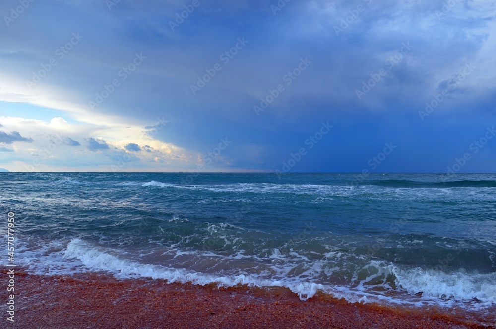 The sea is of immense beauty with waves and thunderclouds in the autumn velvet season.