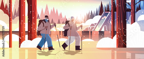 senior african american man woman hikers traveling together with backpacks active old age physical activities