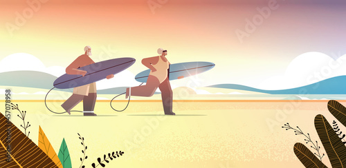 senior couple with surf boards aged man woman surfers holding surfboards summer vacation active old age