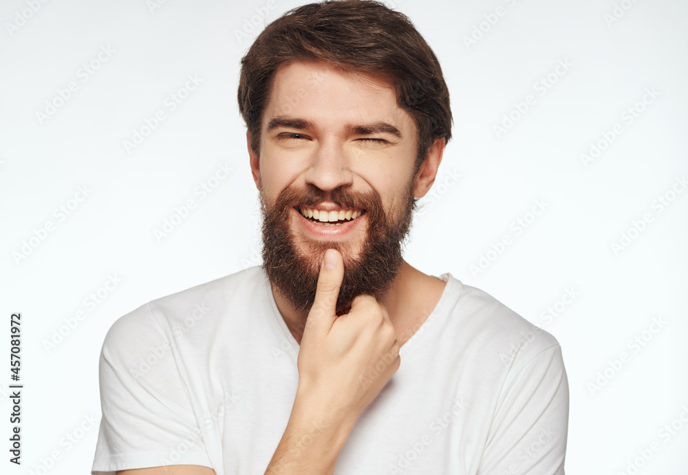 emotional man in a white t-shirt irritated facial expression close-up emotional man in a white t-shirt irritated facial expression close-up