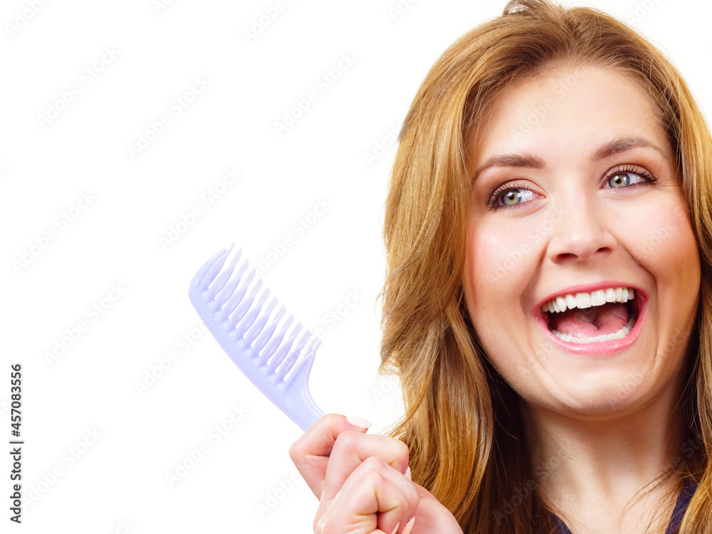 Woman long healthy brown hair holds comb Woman long healthy brown hair holds comb