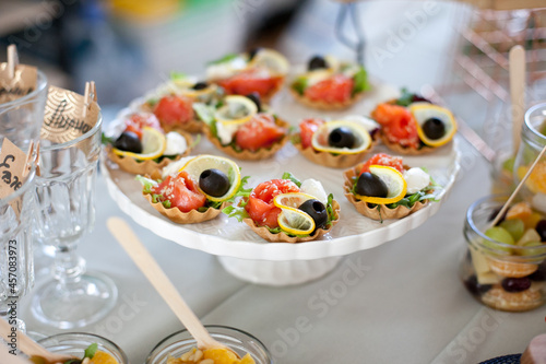 tartlets appetizers with salmon and lemon at buffet table