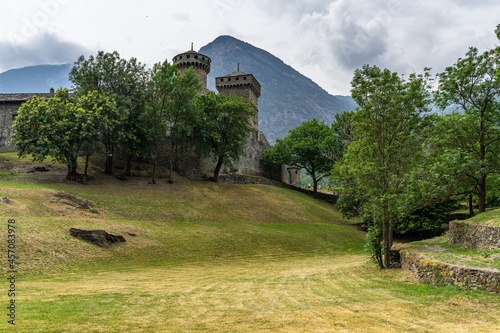 Medieval Fenis Castle in Aosta Valley, Italy seen through growing vegetation photo