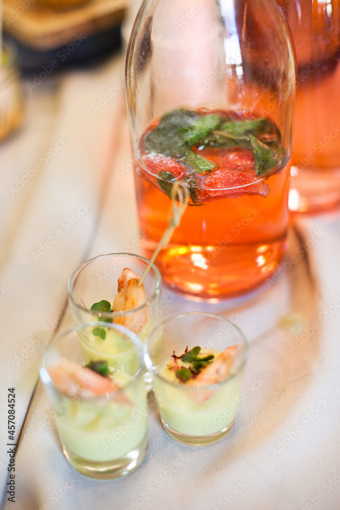 Fototapeta premium Shrimp cocktail and strawberry lemonade on the table at the party