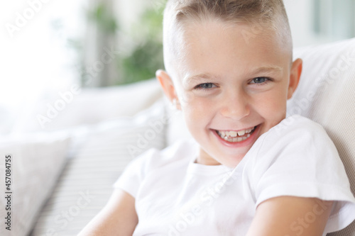 Free Download Portrait of laughing happy handsome boy, joyful child, little cheerful kid smiling on home background, copy space - GFXLoad