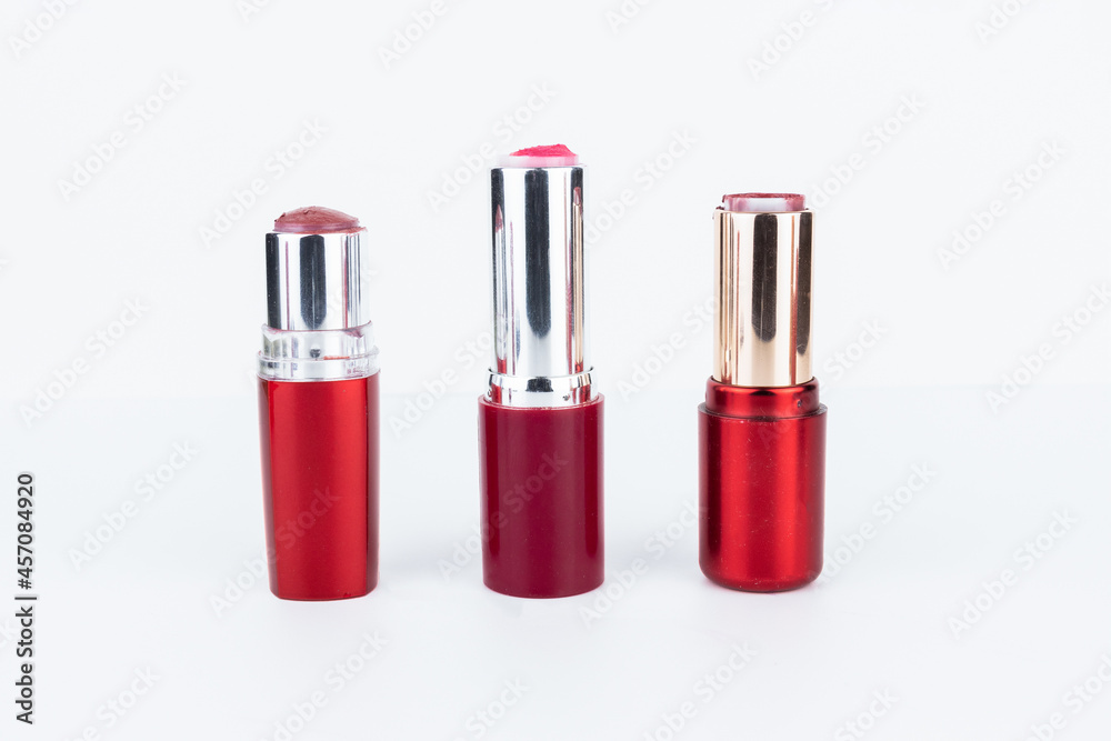 Three old out of lipsticks in red tubes Three old out of lipsticks in red tubes