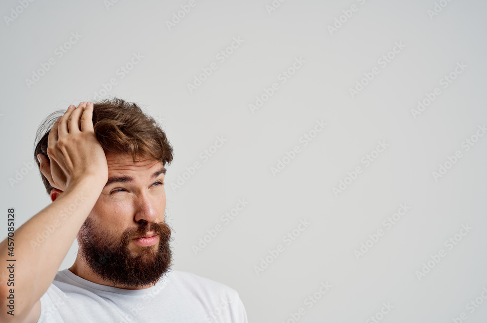 man in a white t-shirt headache migraine problems light background man in a white t-shirt headache migraine problems light background