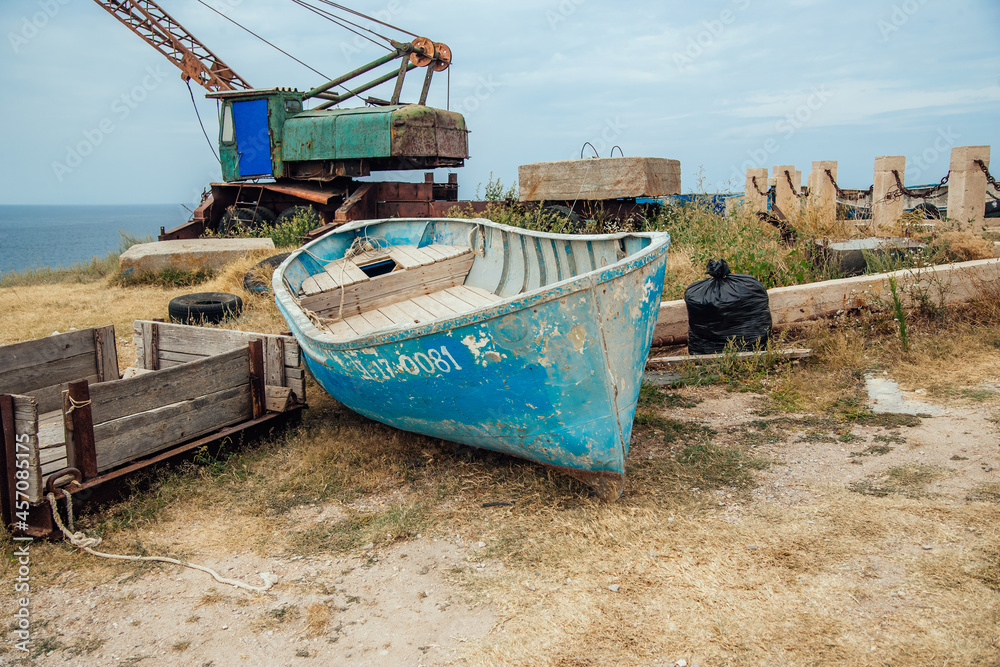 boats and a crane at a fishing shelter boats and a crane at a fishing shelter