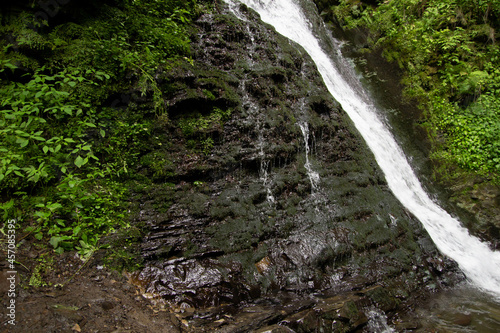 Mountain waterfall, rock with moss