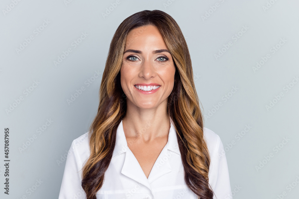 Photo of young cute brown hairdo lady wear white nurse coat isolated on grey background Photo of young cute brown hairdo lady wear white nurse coat isolated on grey background