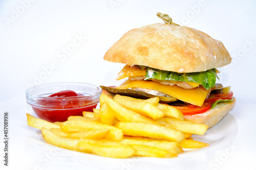 The burger and fries with tomato sauce.