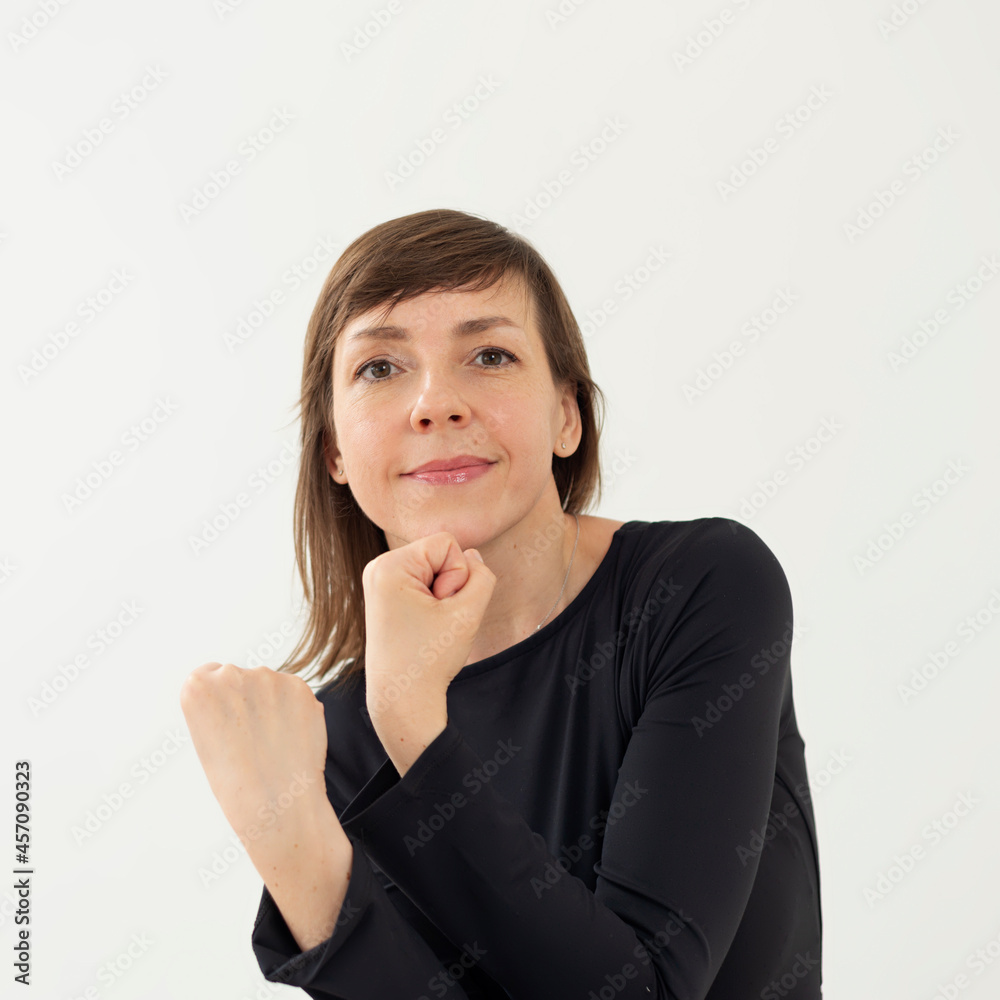 Woman holding hands with fists and smiling
Woman holding hands with fists and smiling