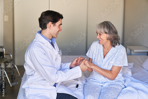 Elderly carer holds hands of a senior citizen as a consolation
