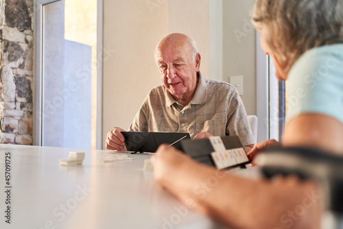 Senior with dementia playing Rummikub in the nursing home