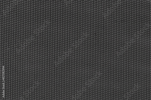 The texture of an artificial black fabric. Abstract dark black background for wallpaper, design 