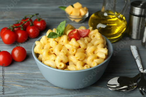 Concept of tasty eating with macaroni with cheese on wooden background