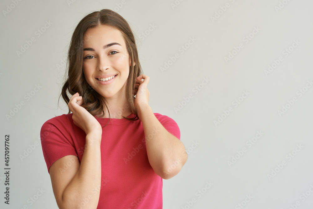 cheerful woman holding on to hair cosmetics isolated background cheerful woman holding on to hair cosmetics isolated background