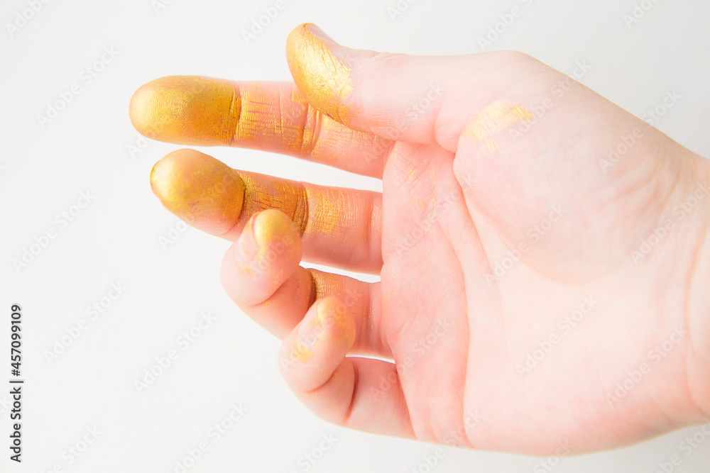 Palm fingertips stained with gold paint Palm fingertips stained with gold paint