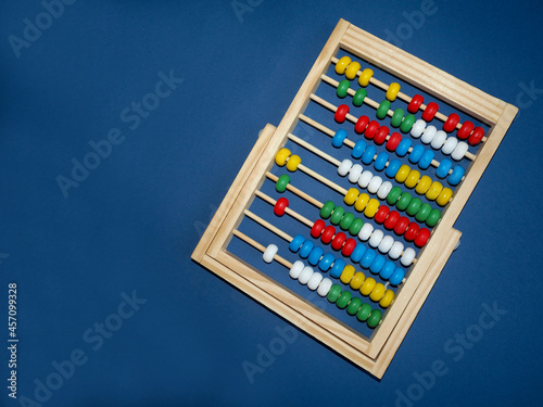 on the right  wooden children s abacus stand on a blue background  top view. preschool education for children