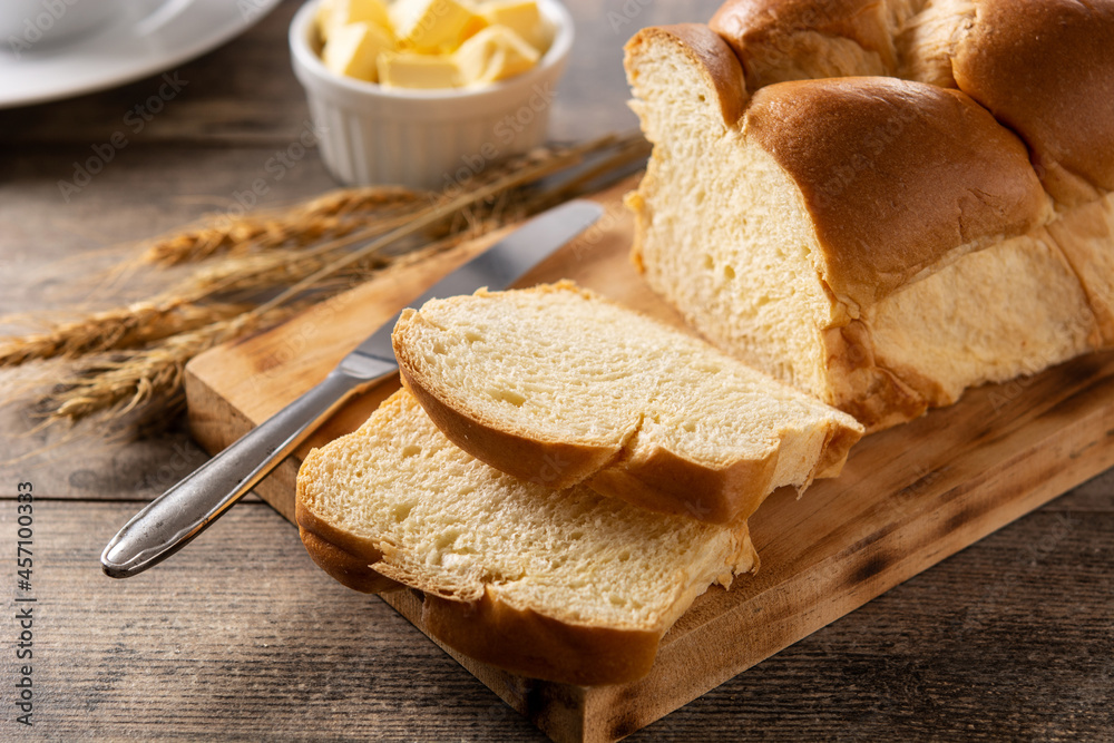 Braided egg bread on wooden table	