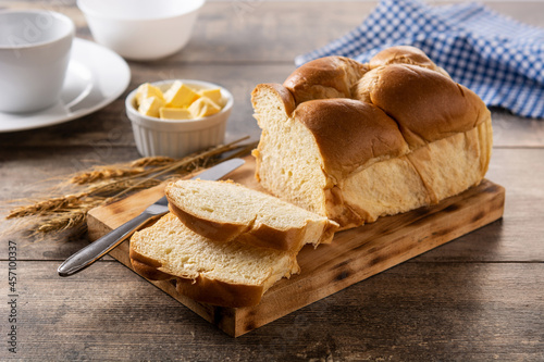 Braided egg bread on wooden table	 photo