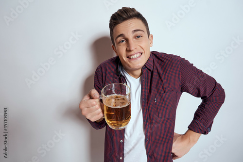 Cheerful man with beer in the hands of fun alcohol