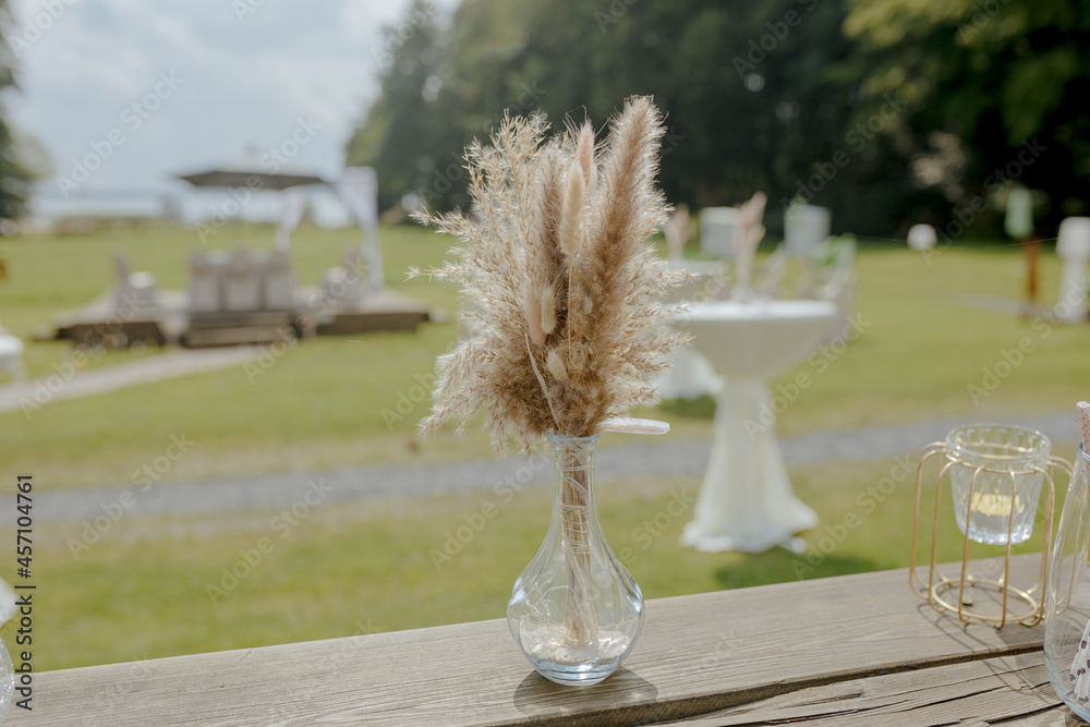 Boho decoration. Free wedding ceremony in summer. Love. Outdoor wedding ceremony by the lake next to a forest in Germany. pampas grass 