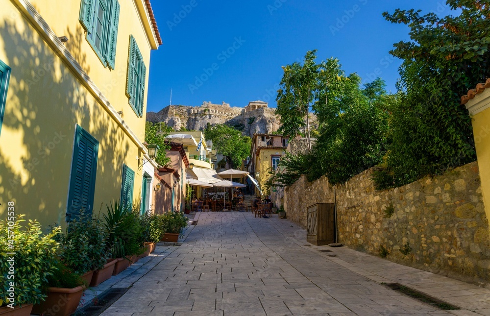 Athens street with yellow house, with the acropolis at the end above the mount