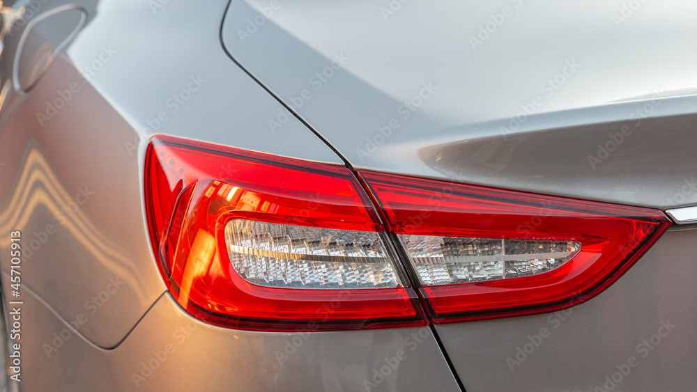 The red headlight of a modern sedan metallic car. Rear stop light. Premium LED sedan taillights