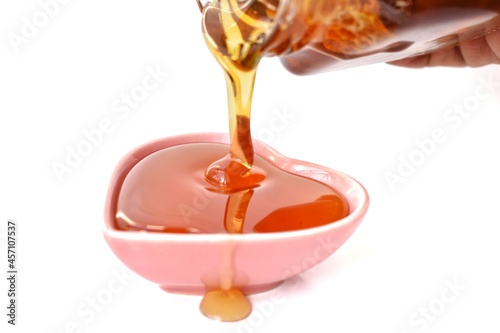 honey dripping from a glass