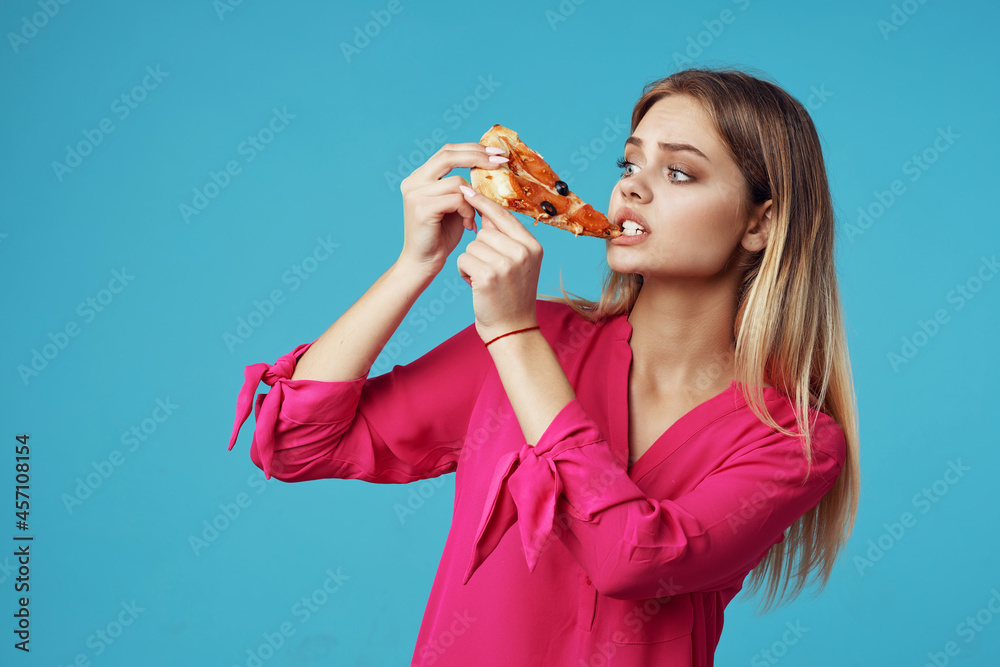 woman in a pink shirt with pizza in her hands junk food close-up woman in a pink shirt with pizza in her hands junk food close-up