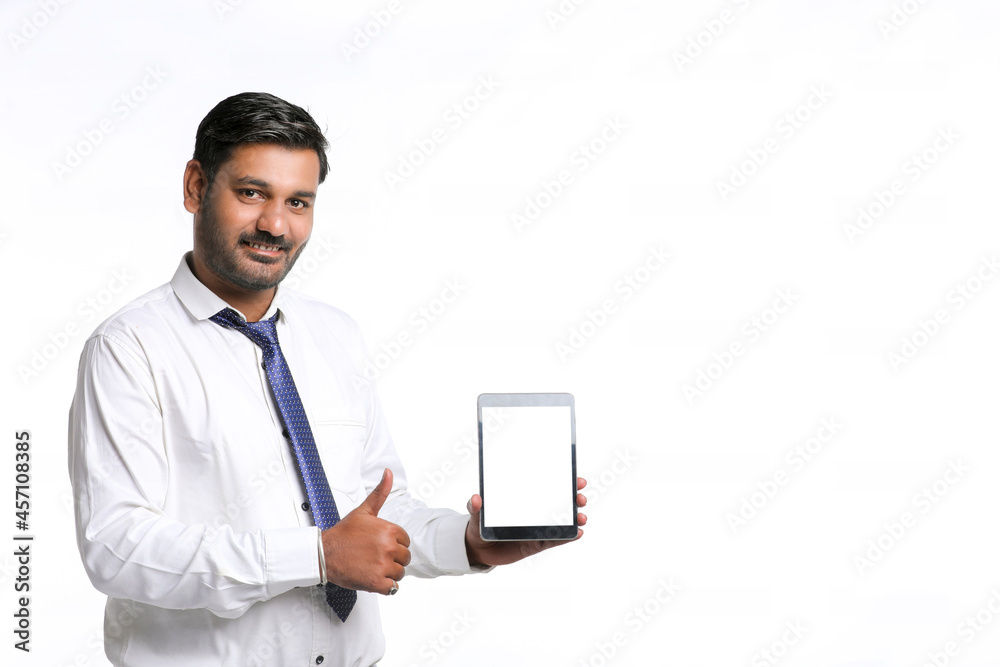 Young indian officer showing tablet screen on white background. Young indian officer showing tablet screen on white background.