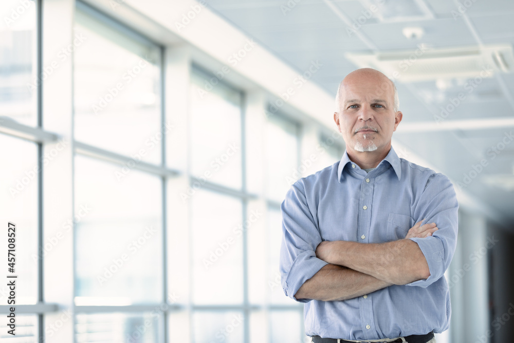 Low angle view of a thoughtful senior businessman Low angle view of a thoughtful senior businessman