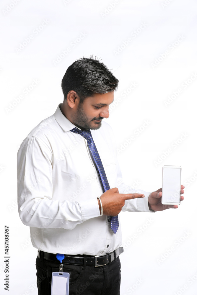 Young indian officer showing smartphone screen on white background.