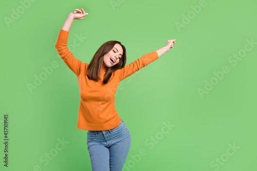 Portrait of attractive cheerful dreamy slim girl having fun dancing weekend isolated over green color background