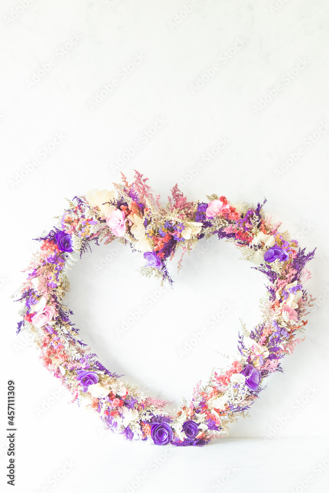 Colorful heart shaped flower arrangement with white background