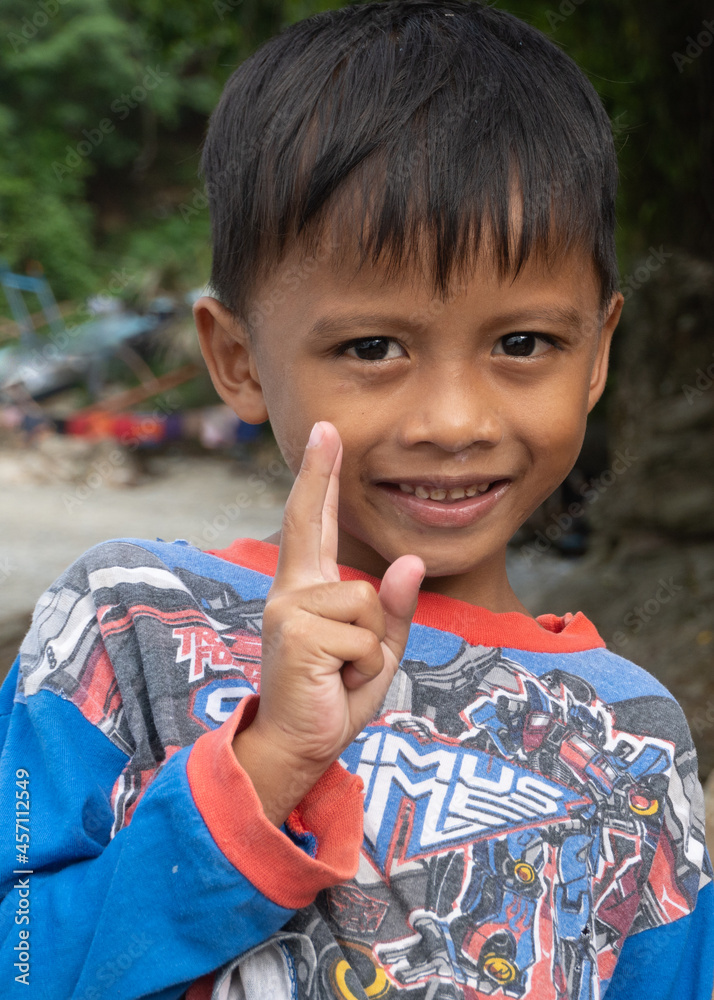 Fishing village boy waiting for his grandfather to come home with the