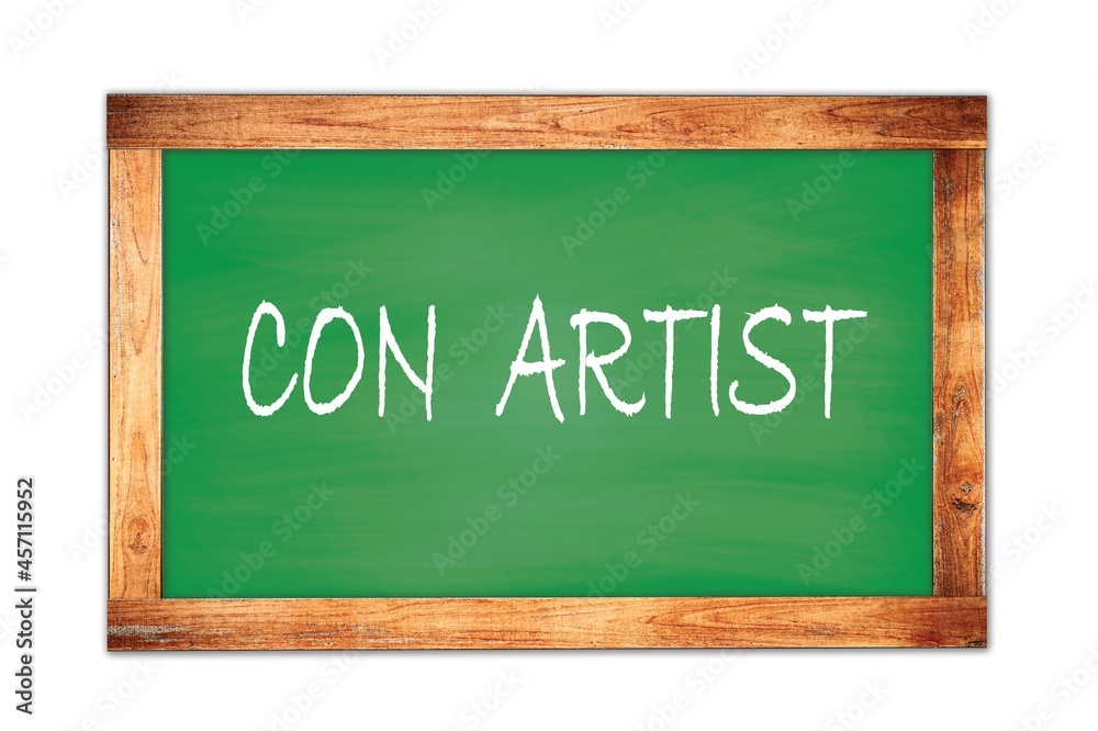 CON ARTIST text written on green school board. CON ARTIST text written on green school board.