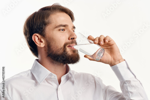 handsome man glass of water light background