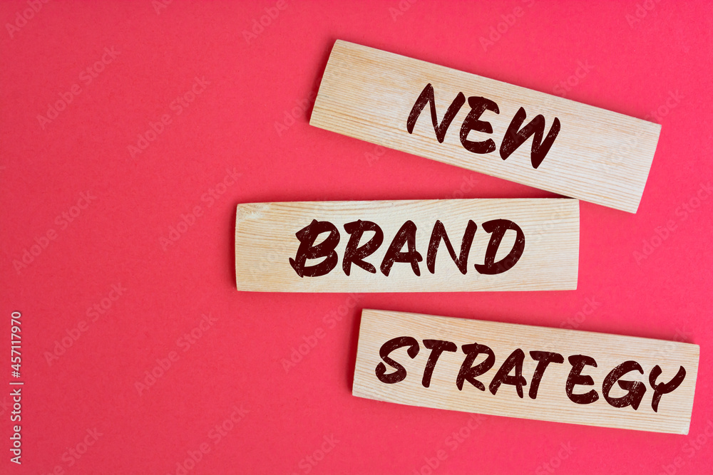 New Brand Strategy Text on Wooden Blocks on red Background New Brand Strategy Text on Wooden Blocks on red Background