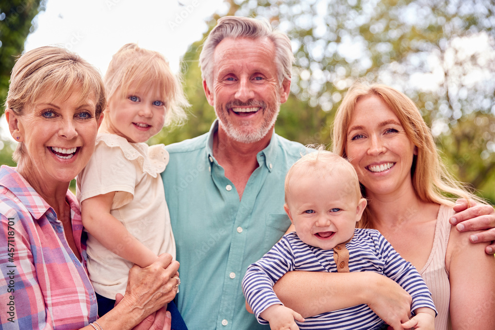 Portrait Of Smiling Grandparents With Mother And Grandchildren At Home In Garden Together Portrait Of Smiling Grandparents With Mother And Grandchildren At Home In Garden Together