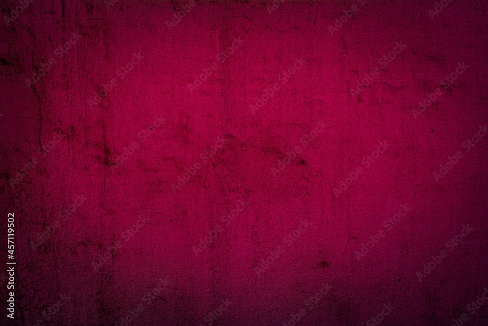 Old red wall in spots, cracks, stains. Painted concrete wall in abstract grunge style loft. Vintage wall background texture for backgrounds, portraits, posters.