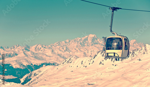 Vintage ski cable car, snowy moun landscape in winter, the Mont-Blanc in the background, the Alps, France