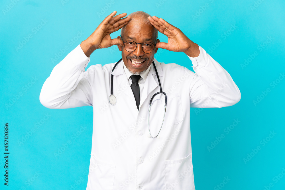 Senior doctor man isolated on blue background with surprise expression
