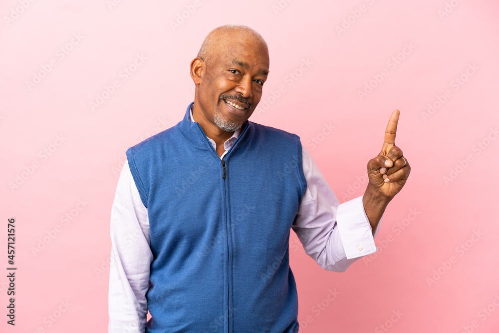 Cuban senior isolated on pink background showing and lifting a finger in sign of the best Cuban senior isolated on pink background showing and lifting a finger in sign of the best