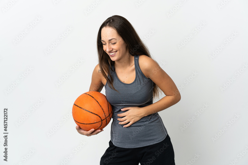 Young woman playing basketball over isolated white background smiling a lot