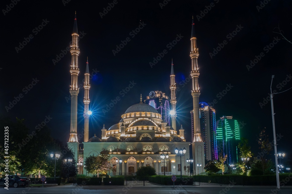  Russia, Chechnya, the Chechen Republic, the city of Grozny. Night view of the mosque the heart of Chechnya against the backdrop of skyscrapers Grozny city