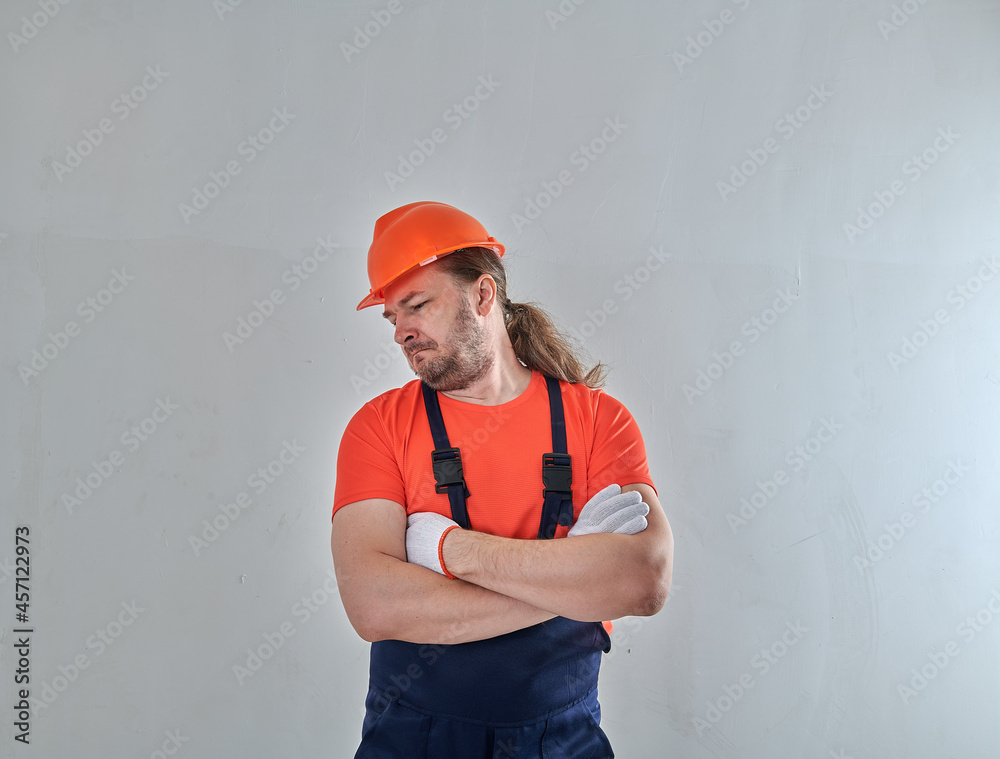 repairman on a white wall background stands repairman on a white wall background stands